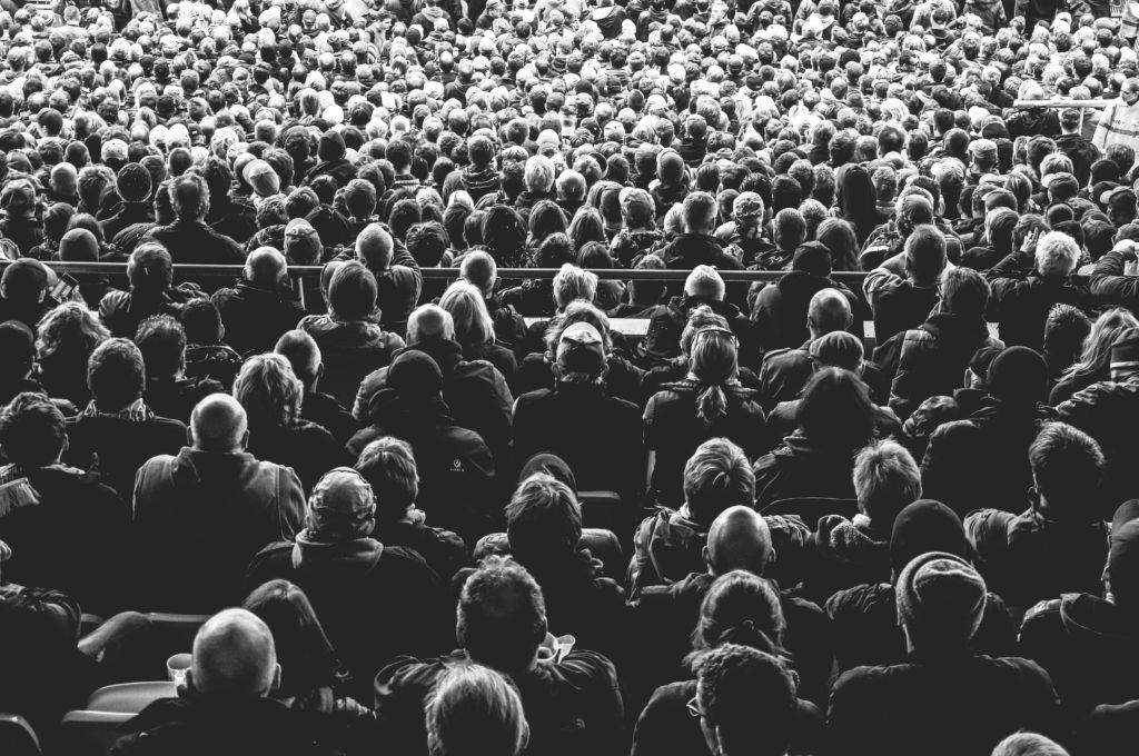 a black and white photo of a crowd of people